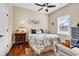 Cozy bedroom with hardwood floors, ceiling fan, natural light, and comfortable bedding at 3736 Kingsley Dr., Myrtle Beach, SC 29588