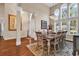 Bright dining room with large windows, hardwood floors, and a chandelier, perfect for entertaining guests at 3736 Kingsley Dr., Myrtle Beach, SC 29588