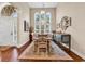 Elegant dining room with a large table, seating for eight, and high windows providing ample natural light at 3736 Kingsley Dr., Myrtle Beach, SC 29588