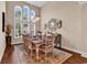 Open dining room featuring hardwood floors, high ceilings, and abundant natural light from large windows at 3736 Kingsley Dr., Myrtle Beach, SC 29588