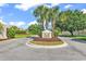 Inviting entrance to Queen's Harbour Estates featuring lush landscaping and a prominent community sign at 3736 Kingsley Dr., Myrtle Beach, SC 29588