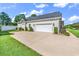 Two-car garage with lush landscaping and well-maintained lawn and white picket fence at 3736 Kingsley Dr., Myrtle Beach, SC 29588