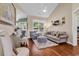 Cozy living room with large windows, hardwood floors, plush seating, and elegant decorative touches at 3736 Kingsley Dr., Myrtle Beach, SC 29588