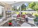 Relaxing screened-in porch leading to an outdoor patio with dining and lounge areas for enjoying the backyard at 3736 Kingsley Dr., Myrtle Beach, SC 29588