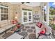 Charming screened porch with comfortable sofas, brick accents, and outdoor views, perfect for relaxing and entertaining at 3736 Kingsley Dr., Myrtle Beach, SC 29588