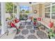 Inviting screened porch with comfortable seating, decorative pillows, and views of the surrounding greenery at 3736 Kingsley Dr., Myrtle Beach, SC 29588