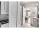 Bathroom and laundry featuring a washer/dryer combo; a peek into the adjacent main bedroom at 3939 Gladiola Ct. # 202, Myrtle Beach, SC 29588