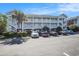 Exterior view of condo building with multiple units, parking, and stairwells at 3939 Gladiola Ct. # 202, Myrtle Beach, SC 29588