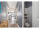 Inviting hallway with wood-look floors that leads to the kitchen and includes a convenient half bathroom at 3939 Gladiola Ct. # 202, Myrtle Beach, SC 29588