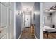 Hallway with durable floors and decor leads to a bedroom; a shoe rack offers storage and a cozy rug adds warmth at 3939 Gladiola Ct. # 202, Myrtle Beach, SC 29588