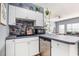 Stylish kitchen boasting white cabinetry, dark countertops, and a stainless steel dishwasher at 3939 Gladiola Ct. # 202, Myrtle Beach, SC 29588