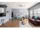 Cozy living room featuring hardwood floors, bright windows, and open access to the kitchen at 3939 Gladiola Ct. # 202, Myrtle Beach, SC 29588