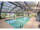 An inviting indoor pool surrounded by chairs and sliding glass doors at 3939 Gladiola Ct. # 202, Myrtle Beach, SC 29588