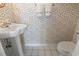 Classic half-bathroom featuring a pedestal sink, toilet, and patterned wallpaper at 4012 Grousewood Dr., Myrtle Beach, SC 29588