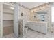 Bright bathroom with large mirror, white vanity, and floral wallpaper at 4012 Grousewood Dr., Myrtle Beach, SC 29588