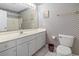 Bathroom with vanity sink, and toilet with a floral accent wall at 4012 Grousewood Dr., Myrtle Beach, SC 29588