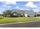 Charming single-story home featuring a well-manicured lawn, brick accents, and an attached two-car garage at 4012 Grousewood Dr., Myrtle Beach, SC 29588