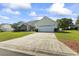 Shot of home with lush lawn, brick accents, two-car garage, and long driveway leading up to the house at 4012 Grousewood Dr., Myrtle Beach, SC 29588