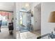 Bright and inviting foyer with tile flooring, decorative glass door, and elegant chandelier at 4012 Grousewood Dr., Myrtle Beach, SC 29588