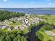 An aerial image highlights a neighborhood bordering a wide river with well-kept landscaping, ponds, and many homes at 417 Grain Field Dr., Georgetown, SC 29440