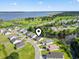 An aerial view captures the beauty of a waterfront community with lush landscaping and homes surrounding a pond and river at 417 Grain Field Dr., Georgetown, SC 29440
