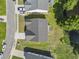 An aerial perspective features a well-maintained home with a gray roof, green lawn and backyard pond at 417 Grain Field Dr., Georgetown, SC 29440