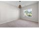 Bedroom features a carpeted floor, large window with a view, and a modern ceiling light at 417 Grain Field Dr., Georgetown, SC 29440