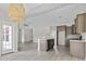 Open-concept kitchen and living room with stainless steel appliances, a stylish island, and ample counter space at 417 Grain Field Dr., Georgetown, SC 29440