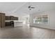 Spacious living room open to the kitchen, featuring neutral walls, wood floors, and large windows at 417 Grain Field Dr., Georgetown, SC 29440