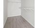 Walk-in closet featuring wood-look floors, white walls, and shelves at 417 Grain Field Dr., Georgetown, SC 29440