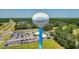 Aerial view of the water tower in Little River with a background of lush greenery and a well-organized parking lot at 4206 Pinehurst Circle # E8, Little River, SC 29566