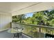 Relax on this balcony with a glass table and enjoy the peaceful views of the surrounding golf course and lush greenery at 4206 Pinehurst Circle # E8, Little River, SC 29566