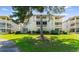 View of the well-maintained condo building, highlighting unit E8 with its private balcony and serene surroundings at 4206 Pinehurst Circle # E8, Little River, SC 29566