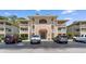 Attractive multi-story condo building with balconies and parking area on a sunny day at 4206 Pinehurst Circle # E8, Little River, SC 29566