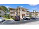 Multi-story condo building with spacious balconies and parking lot on a beautiful day at 4206 Pinehurst Circle # E8, Little River, SC 29566