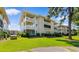 Well-maintained condo complex featuring multiple balconies, manicured landscaping, and a lush green lawn, perfect for outdoor living at 4206 Pinehurst Circle # E8, Little River, SC 29566