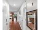 Hallway view leading to a kitchen, showcasing wooden cabinets and interior doors at 4206 Pinehurst Circle # E8, Little River, SC 29566