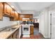 Bright kitchen includes wooden cabinets, countertops, stove, and an open view of the living room at 4206 Pinehurst Circle # E8, Little River, SC 29566