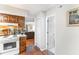 Kitchen adjacent to a hallway, showcasing wooden cabinets and modern appliances at 4206 Pinehurst Circle # E8, Little River, SC 29566