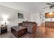 Comfortable living room with a brown sofa, wood floors, and plenty of natural light at 4206 Pinehurst Circle # E8, Little River, SC 29566