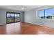 Bright bedroom featuring wood floors, a ceiling fan, and access to a balcony with a view at 4350 Intercoastal Dr. # 2408, Little River, SC 29566