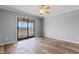 Bright bedroom with hardwood floors and sliding glass doors to screen porch at 4350 Intercoastal Dr. # 2408, Little River, SC 29566