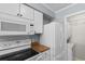 Updated kitchen featuring white appliances, cabinets, and adjacent laundry area at 4350 Intercoastal Dr. # 2408, Little River, SC 29566