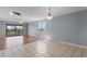 Spacious living area with mixed flooring, balcony access, and natural light from a window at 4350 Intercoastal Dr. # 2408, Little River, SC 29566