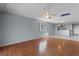 Open living area with wood flooring, a ceiling fan, and a connecting kitchen with tile flooring at 4350 Intercoastal Dr. # 2408, Little River, SC 29566