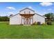 Exterior view of white barn with wooden details, accent lighting, and green lawn at 4499 Highway 308, Aynor, SC 29544