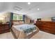 Cozy bedroom featuring wood paneled walls, dormer windows and wood furniture at 4499 Highway 308, Aynor, SC 29544