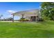 Exterior view of a covered carport next to a home with lush green grass at 4499 Highway 308, Aynor, SC 29544