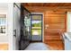 Charming entryway with wood plank walls, view to outdoors, and welcome wreath at 4499 Highway 308, Aynor, SC 29544
