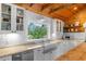 Bright kitchen features a farmhouse sink, stainless steel appliances and a white tile backsplash, with a lovely view at 4499 Highway 308, Aynor, SC 29544